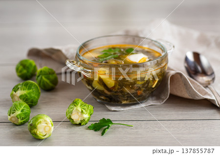 Hot green sorrel soup with Brussels sprouts in a bowl Hot green sorrel soup with Brussels sprouts in a bowl 137855787