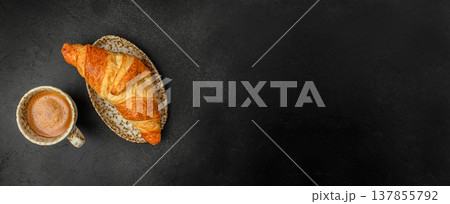 Croissant and Coffee Cup on Black Background 137855792