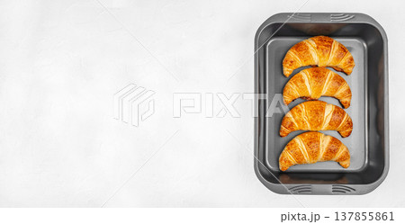 Baked Croissants in Metal Baking Pan on White Background 137855861