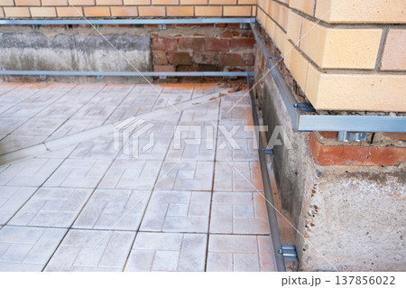 Repair of the foundation and walls of the house with the installation of metal sheets on the frame for finishing the basement. Repair of the foundation and walls of the house with the installation of metal sheets on the frame for finishing the basement. 137856022