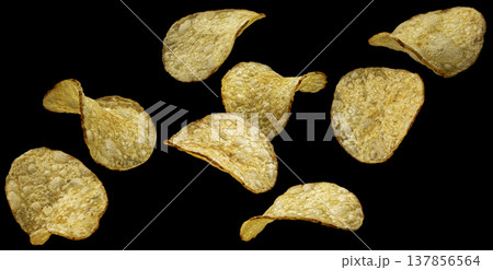 Falling natural kettle potato chips isolated on black background, full depth of field, collection Falling natural kettle potato chips isolated on black background, full depth of field, collection 137856564