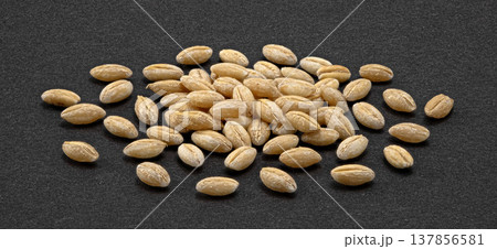 Barley grain pile on dark background, natural whole cereal ingredient, full depth of field, top view Barley grain pile on dark background, natural whole cereal ingredient, full depth of field, top view 137856581