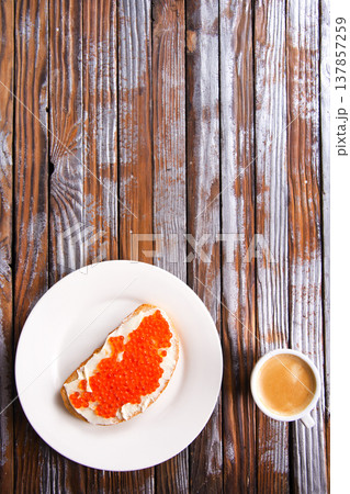 Sandwiches with red caviar, salmon on a slice of bread with cream cheese. Sandwiches with red caviar, salmon on a slice of bread with cream cheese. 137857259