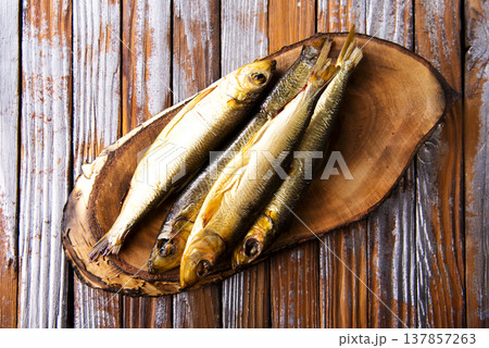 smoked fish on wooden board smoked fish on wooden board 137857263