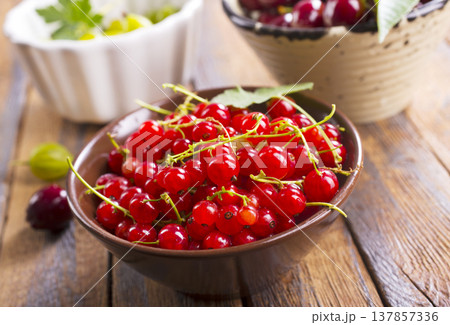 Red currant berries, fresh ripe and raw redcurrants in a claim bowl. Ready to eat spherical edible fruits 137857336
