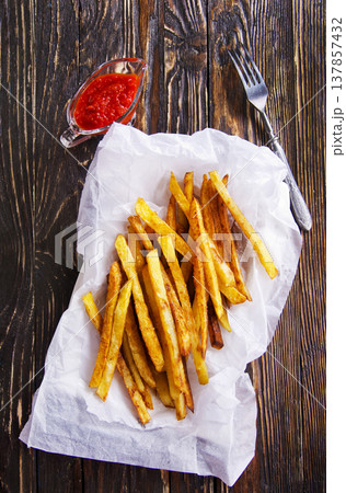 Homemade French fries with ketchup, homemade roasted in the air fryer. Homemade French fries with ketchup, homemade roasted in the air fryer. 137857432
