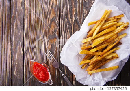 Homemade French fries with ketchup, homemade roasted in the air fryer. Homemade French fries with ketchup, homemade roasted in the air fryer. 137857436