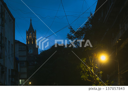 Streets of Colaba in Mumbai, India at evening time. Beautiful buildings in British style Streets of Colaba in Mumbai, India at evening time. Beautiful buildings in British style 137857843