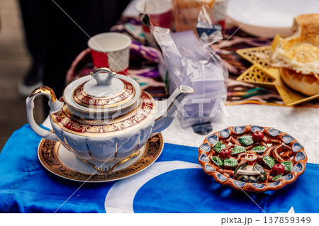 Uzbek teapot on the festive table Nauryz. hot drink on the holiday of friendship of peoples Uzbek teapot on the festive table Nauryz. hot drink on the holiday of friendship of peoples 137859349