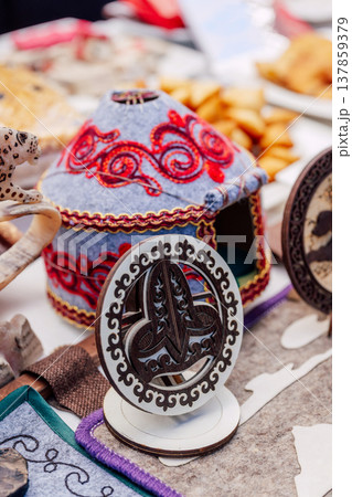 national kazakh souvenirs on the table. kazakh toy yurt and wooden figurine national kazakh souvenirs on the table. kazakh toy yurt and wooden figurine 137859379