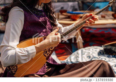 Skillful Woman Enjoying Traditional Tune With Detailed Surroundings Highlighting Cultural Ambiance 137859380