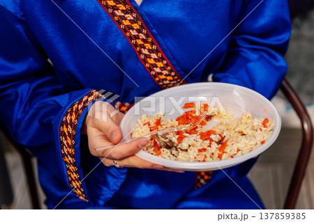Celebration With Rice And Garments. Outdoor Festivity Holding Rice Dish And Decorative Attire Celebration With Rice And Garments. Outdoor Festivity Holding Rice Dish And Decorative Attire 137859385
