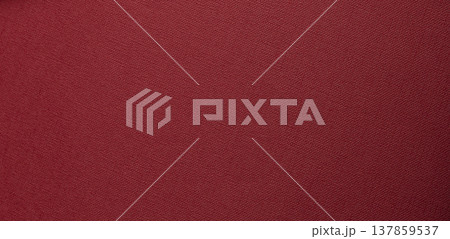 deep red textured background with flat surface. Fine woven grain and matte tactile material create a deep red textured background with flat surface. Fine woven grain and matte tactile material create a 137859537