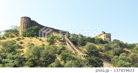 Hilltop view of Jaigarh Fort with its massive ramparts and stair-lined defensive wall stretching Hilltop view of Jaigarh Fort with its massive ramparts and stair-lined defensive wall stretching 137859625
