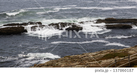Barrier Rocks with Ocean Waves Crashing and Rolling OVer Them in Galicia Spain Barrier Rocks with Ocean Waves Crashing and Rolling OVer Them in Galicia Spain 137860187