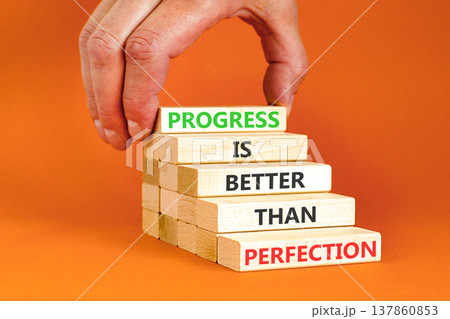 Progress or perfection words symbol. Concept words Progress is better than perfection on beautiful wooden blocks. Beautiful orange paper background. Business progress or perfection concept. Copy space 137860853