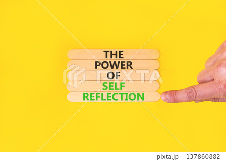 Self reflection symbol. Concept words The power of self reflection on beautiful wooden sticks. Beautiful yellow background. Businessman hand. Business the power of self reflection concept. Copy space. 137860882
