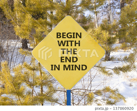 Begin with the end in mind symbol. Concept words Begin with the end in mind on beautiful yellow road sign. Beautiful winter forest background. Business begin with the end in mind concept. Copy space. Begin with the end in mind symbol. Concept words Begin with the end in mind on beautiful yellow road sign. Beautiful winter forest background. Business begin with the end in mind concept. Copy space. 137860920