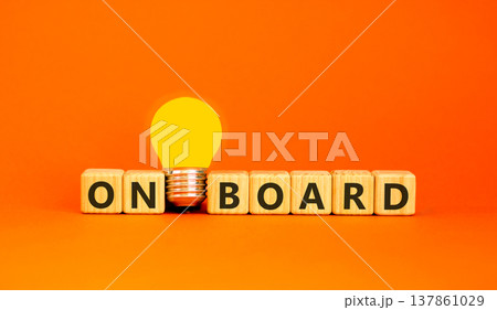 Onboard and onboarding symbol. The concept word Onboard on wooden cubes. Beautiful orange background. Beautiful yellow light bulb. Copy space. Business onboard and onboarding concept. 137861029