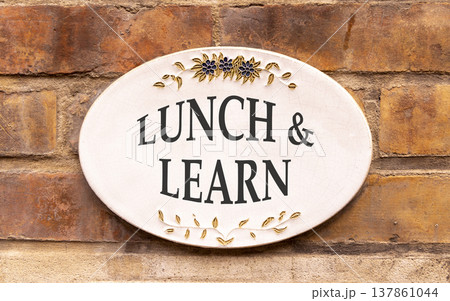 Lunch and learn symbol. Concept words Lunch and learn on beautiful big white sign plate. Beautiful old brown brick wall background. Business, educational and lunch and learn concept. Copy space. Lunch and learn symbol. Concept words Lunch and learn on beautiful big white sign plate. Beautiful old brown brick wall background. Business, educational and lunch and learn concept. Copy space. 137861044