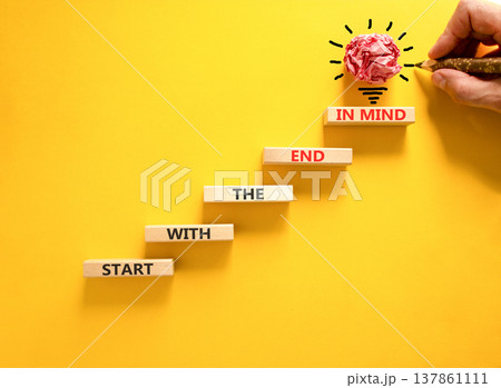 Start with the end in mind symbol. Concept words Start with the end in mind on beautiful wooden blocks. Beautiful yellow paper background. Business start with the end in mind concept. Copy space. 137861111