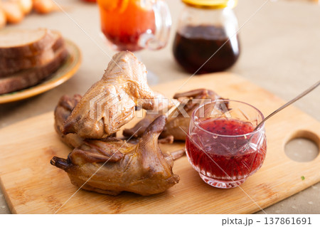 Baked Partridge Served on Cutting Board 137861691