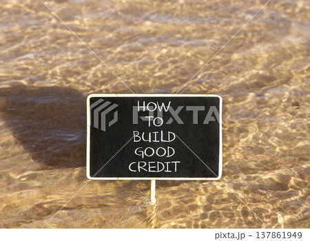 How to build good credit symbol. Concept words How to build good credit on beautiful black blackboard. Beautiful sea water background. Business how to build good credit concept. Copy space. How to build good credit symbol. Concept words How to build good credit on beautiful black blackboard. Beautiful sea water background. Business how to build good credit concept. Copy space. 137861949