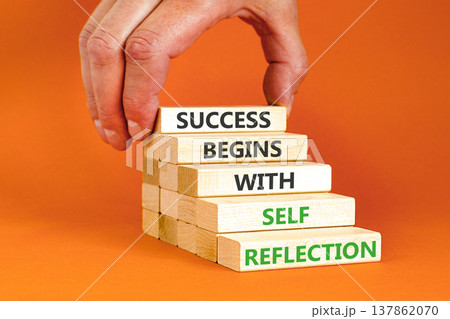 Self reflection symbol. Concept words Success begins with self reflection on beautiful wooden blocks. Beautiful orange background. Business success begins with self reflection concept. Copy space. 137862070