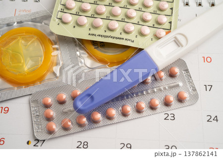 Pregnancy test and birth control pills on calendar, contraception health and medicine. Pregnancy test and birth control pills on calendar, contraception health and medicine. 137862141