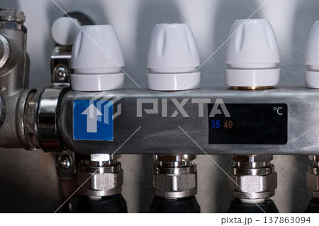 Complex residential heating manifold system with valves, gauges, and piping network Complex residential heating manifold system with valves, gauges, and piping network 137863094