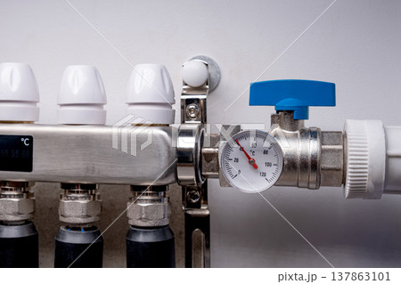 Complex residential heating manifold system with valves, gauges, and piping network 137863101