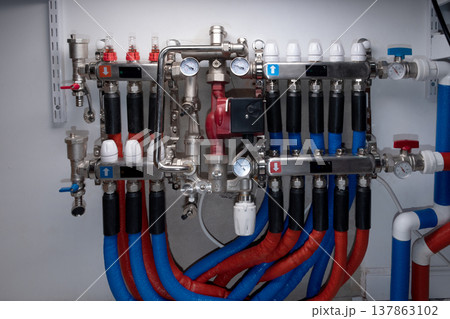 Complex residential heating manifold system with valves, gauges, and piping network 137863102