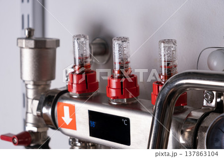 Complex residential heating manifold system with valves, gauges, and piping network 137863104