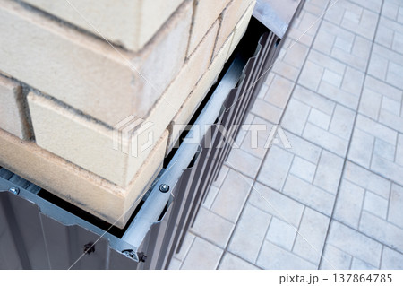 Repair of the foundation and walls of the house with the installation of metal sheets on the frame for finishing the basement. 137864785