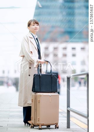 都会でタクシーを待つ若いビジネスウーマン 都会でタクシーを待つ若いビジネスウーマン 137865687