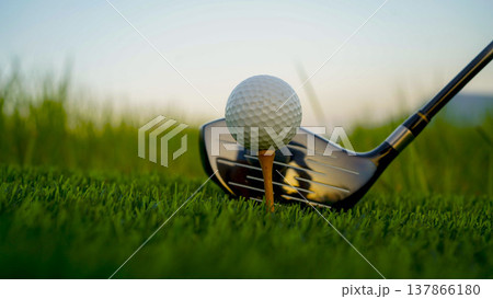 Golf clubs and balls on a green lawn in a beautiful golf course with morning sunshine. 137866180