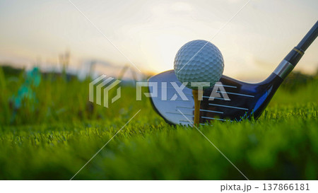 Golf clubs and balls on a green lawn in a beautiful golf course with morning sunshine. Golf clubs and balls on a green lawn in a beautiful golf course with morning sunshine. 137866181