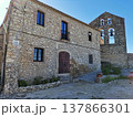 Rustic stone house and old church bell tower in Castellet village, Spain. 137866301