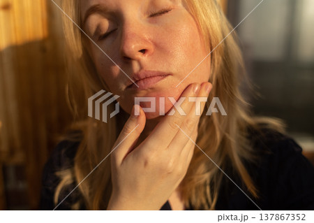 Close-up of female face with enlarged pores and oily skin, visible texture, redness on chin. Natural light beauty portrait, skincare concerns, dermatology concept. 137867352