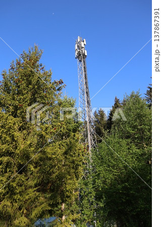 A tall tower with a cell phone antenna on top A tall tower with a cell phone antenna on top 137867391