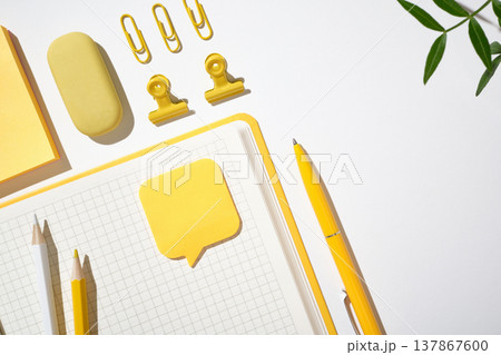 Minimalist workspace arrangement with scissors, pencils, and clips on a white background. Copyspace 137867600