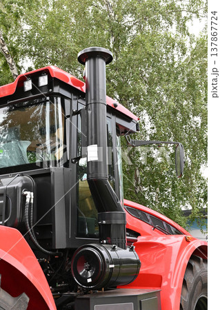 Tractor with exhaust system at farm location Tractor with exhaust system at farm location 137867724