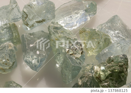 Raw Aquamarine Gemstones Displayed With Natural Green And Blue Hues On White Background For Jewelry Design Inspiration Raw Aquamarine Gemstones Displayed With Natural Green And Blue Hues On White Background For Jewelry Design Inspiration 137868125