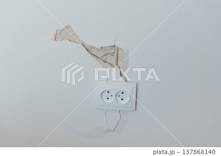 Damaged White Wall With Peeling Paint Around Electrical Outlet Showing Cracks And Exposed Plaster In Neutral Tone Interior Scene Damaged White Wall With Peeling Paint Around Electrical Outlet Showing Cracks And Exposed Plaster In Neutral Tone Interior Scene 137868140