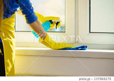 Woman cleaning windowsill 137868278