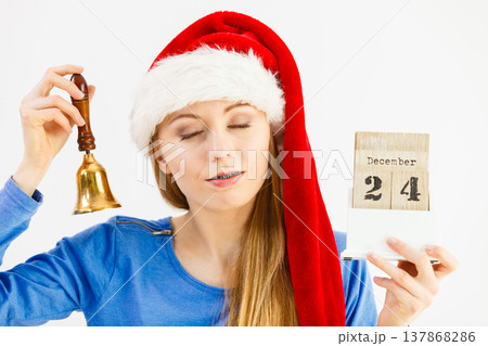 Woman and christmas calendar with bell Woman and christmas calendar with bell 137868286