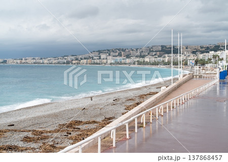 Nice seafront promenade and pebble beach under stormy sky in France Nice seafront promenade and pebble beach under stormy sky in France 137868457