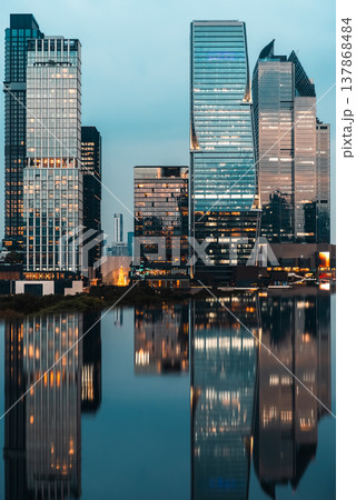 big city skyline at sunset with mirrored water reflection, modern high-rise skyscrapers at golden hour urban dusk, downtown mirroring on swimming pool, Bangkok Thailand big city skyline at sunset with mirrored water reflection, modern high-rise skyscrapers at golden hour urban dusk, downtown mirroring on swimming pool, Bangkok Thailand 137868484
