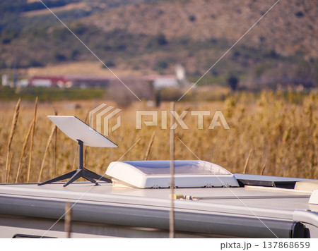 Caravan roof with equipment Starlink terminal satellite dish, sunroof and awning on side Caravan roof with equipment Starlink terminal satellite dish, sunroof and awning on side 137868659