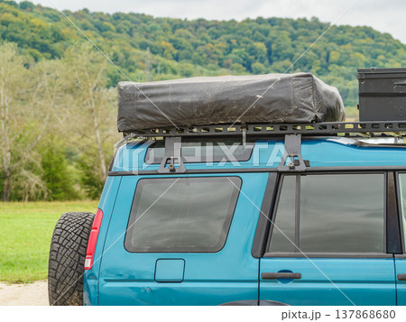 Off road vehicle with roof top tent and storage box camping on nature Off road vehicle with roof top tent and storage box camping on nature 137868680